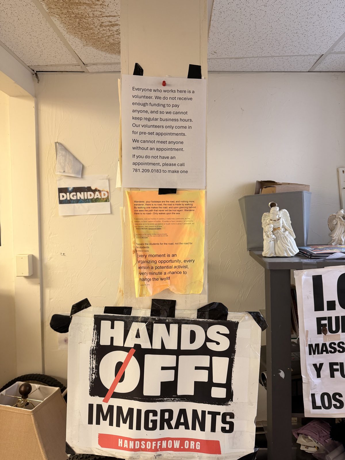 Volunteer information and immigrant rights signs inside the TRII office